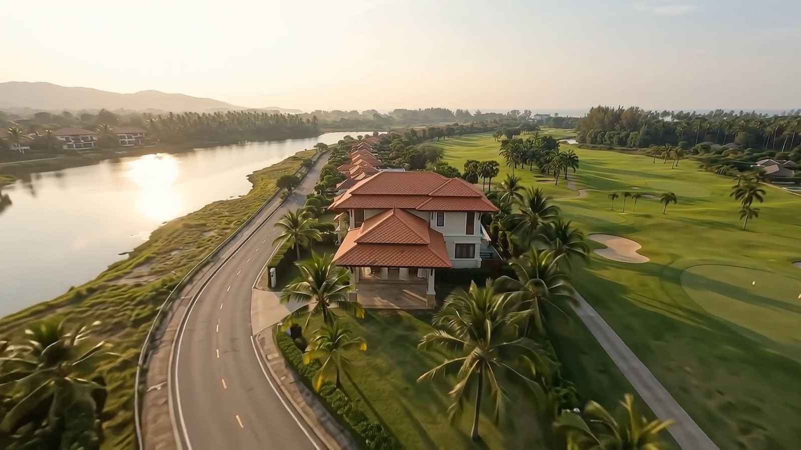 Aerial view of lagoon-side villas next to a golf course